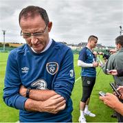 1 September 2014; Republic of Ireland manager Martin O'Neill leaves after being interviewed by print media as goalkeeper Shay Given is interviewed by broadcast media during a press conference ahead of their side's International friendly match against Oman on Wednesday. Republic of Ireland Press Conference, Gannon Park, Malahide, Co. Dublin. Picture credit: Brendan Moran / SPORTSFILE