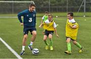 1 September 2014; Republic of Ireland players David Meyler, Robbie Brady and Anthony Pilkington today visited the eFlow FAI Summer Soccer Schools Golden Camp in Gannon Park, Malahide. This year’s Summer Soccer Schools proved to be the FAI’s most successful ever, with over 23,000 participants on more than 330 camps nationwide. A special Golden Camp was held for those who participated on a 2014 eFlow FAI Summer Soccer School and purchased a 2014 FAI Season Ticket. Golden Camp participants were coached by FAI international coaching staff, watched senior men’s team training and met players afterwards. Participants were also coached by Rachel Graham from our senior women’s squad alongside Robbie Brady, Anthony Pilkington and Summer Soccer Schools Ambassador David Meyler. See summersoccerschools.ie for details. Pictured at the camp is Robbie Brady with Padraig Nolan, from Carlow, centre, and Ciaran Murray, from Balbriggan, Co. Dublin. Gannon Park, Malahide, Co. Dublin. Picture credit: Ramsey Cardy / SPORTSFILE