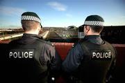 16 December 2006. Members of the Police Service of Northern Ireland riot squad observe the Oval from a bridge beside the ground. Carnegie Premier League, Glentoran v Cliftonville, The Oval, Belfast. Picture credit: Russell Pritchard / SPORTSFILE