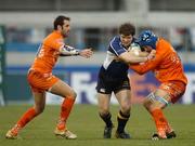 16 December 2006; Gordon D'Arcy, Leinster, is tackled by Jerome Miquel, left, and Mathieu Lievremont, Agen. Heineken Cup 2006-2007, Pool 2, Round 4, Agen v Leinster, Stade Armandie, Agen, France. Picture credit: Pat Murphy / SPORTSFILE