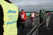 17 December 2006; Competitors come through the finish line after the Aware 10K Christmas Fun Run. Papal Cross, Phoenix Park, Dublin. Picture credit: Tomas Greally / SPORTSFILE *** Local Caption ***