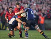 27 December 2006;  Ronan O'Gara, Munster, is tackled by Stanley Wright and Trevor Hogan, Leinster. Magners League, Munster v Leinster, Thomond Park, Limerick. Picture credit: Kieran Clancy / SPORTSFILE