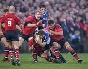 27 December 2006; Brian O'Driscoll, Leinster, is tackled by Federico Pucciariello, Paul O'Connell and Donncha O'Callaghan, Munster. Magners League, Munster v Leinster, Thomond Park, Limerick. Picture credit: Kieran Clancy / SPORTSFILE