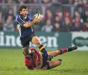 27 December 2006; Gordon D'Arcy, Leinster, is tackled by David Wallace, Munster. Magners League, Munster v Leinster, Thomond Park, Limerick. Picture credit: Kieran Clancy / SPORTSFILE