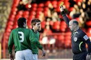 30 December 2006; Cullen Feeney, Glentoran, is shown the yellow card by Referee Mark Courtney while team-mate Kyle Neil looks on. Carnegie Premier League, Glentoran v Portadown, The Oval, Belfast, Co. Antrim. Picture credit: Russell Pritchard / SPORTSFILE