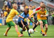 31 August 2014; Somto Ogwude, Bracken Educate Together, Castlelands, Dublin, representing Dublin, in action against Ruairí Bannon, St. Mary's Primary School, Fermanagh, left, and Rory Egan, Ballybryan N.S, Offaly, representing Donegal, during the INTO/RESPECT Exhibition GoGames. Croke Park, Dublin. Picture credit: Ramsey Cardy / SPORTSFILE