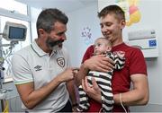 2 September 2014; Republic of Ireland assistant manager Roy Keane with Karol Cearnowska, 9 months old, and her father Batiex, from Co. Fermoy, Co. Cork, during a visit to Temple Street Childrens Hospital, Dublin. Picture credit: David Maher / SPORTSFILE