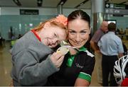 3 September 2014; The Irish Paracycling Team returned from the 2014 UCI Paracycling Road World Championships in Greenville, USA. The Irish team of five bikes won a total of four medals; Eoghan Clifford won double gold in the time trial and road race C3 class, Katie George Dunlevy and Eve McCrystal won silver in the visually impaired tandem road race and handcyclist Mark Rohan won bronze in the H2 time trial. Pictured on her arrival is silver medallist tandem pilot Eve McCrystal, from Dundalk, Co. Louth, with her daughter Nessa, age 5. Dublin Airport, Dublin. Picture credit: Stephen McCarthy / SPORTSFILE