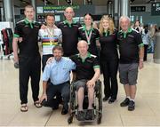 3 September 2014; The Irish Paracycling Team returned from the 2014 UCI Paracycling Road World Championships in Greenville, USA. The Irish team of five bikes won a total of four medals; Eoghan Clifford won double gold in the time trial and road race C3 class, Katie George Dunlevy and Eve McCrystal won silver in the visually impaired tandem road race and handcyclist Mark Rohan won bronze in the H2 time trial. Pictured on their arrival is the Irish team and staff, from left, tandem pilot Bryan McCrystal, Eoghan Clifford, from Galway Bay CC, Co. Galway, who won double gold in the time trial and road race C3 class, Neil Delahaye, manager & coach, silver medallist tandem pilot Eve McCrystal, from Dundalk, Co. Louth, soigneur Paula Kinsella and mechanic Gerry Beggs with, front row, Denis Twomey, President of Cycling Ireland, and  handcyclist Mark Rohan, from Ballinahown, Co. Westmeath, who won bronze in the H2 time trial. Dublin Airport, Dublin. Picture credit: Stephen McCarthy / SPORTSFILE