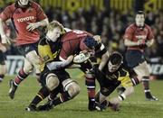 5 January 2007; Athony Foley, Munster, is tackled by Jamie Ringer, left, and Ceri Sweeney, Newport Gwent Dragons. Magners League, Newport Gwent Dragons v Munster, Rodney Parade, Newport, Gwent, Wales. Picture credit: Pat Murphy / SPORTSFILE