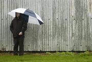 7 January 2007; A lone supporter shelters from the rain during the match. O'Byrne Cup, First Round, Louth v Meath, Gaelic Grounds, Drogheda, Co. Louth. Picture credit: Brian Lawless / SPORTSFILE
