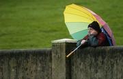 7 January 2007; A spectator shelters from the rain during the match. O'Byrne Cup, First Round, Louth v Meath, Gaelic Grounds, Drogheda, Co. Louth. Picture credit: Brian Lawless / SPORTSFILE