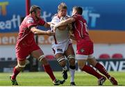 6 September 2014; Chris Henry, Ulster, is tackled by  Scott Williams and Joe Snyman, Scarlets. Guinness PRO12, Round 1, Scarlets v Ulster. Parc Y Scarleys, Llanelli, Wales. Picture credit: Steve Pope / SPORTSFILE