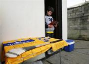 14 January 2007; Colm Fitzgerald, aged 9, son of Clare goalkeeper Davy Fitzgerald reading the match programme outside the dressing rooms. Waterford Crystal Cup, Preliminary Round, Clare v UCC, Meelick, Co. Clare. Picture credit: Kieran Clancy / SPORTSFILE