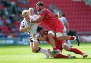 6 September 2014; Stuart Olding, Ulster, is tackled by Rob Evans and Liam Williams, Scarlets. Guinness PRO12, Round 1, Scarlets v Ulster. Parc Y Scarleys, Llanelli, Wales. Picture credit: Steve Pope / SPORTSFILE