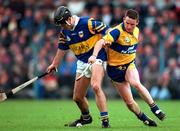 10 May 1997; Brendan Carroll of Tipperary in action against Colin Lynch of Clare during the National Hurling League Division 1 match between Clare and Tipperary at Cusack Park in Ennis. Photo by Ray McManus/Sportsfile
