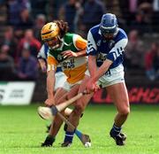 10 May 1997; Ger Oakley of Offaly in action against Paul Delaney of Laois during the National Hurling League Division 1 match between Offaly and Laois at O'Connor Park, Tullamore. Photo by David Maher/Sportsfile