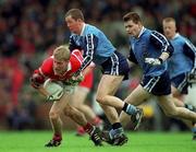 9 May 1999; Anthony Lynch of Cork in action against Brendan O'Brien and Dessie Farrell, right, of Dublin during the Church & General National Football League Final between Cork and Dublin at Páirc Uí Chaoimh in Cork. Photo by Ray McManus/Sportsfile