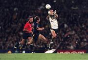 15 October 1999; Ciaran Whelan of Ireland in action against Matthew Allan of Australia followed by umpire Michael Curley during the International Rules Series Second Test match between Ireland and Australia at Football Park in Adelaide, Australia. Photo by Ray McManus/Sportsfile