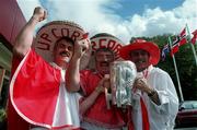 13 September 1999; Cork supporters, from left, Sean, Cyril and Richard Kavanagh, all brothers, from Douglas, Cork with the Liam MacCarthy Cup at the Guinness All-Ireland Senior Hurling Championship Final Post Match Reception at the Burlington Hotel in Dublin. Photo by Brendan Moran/Sportsfile