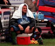 27 September 1999: Peter Clohessy takes shelter from the rain during an Ireland Rugby training session at Garda Club Westmanstown in Lucan, Dublin. Photo by Matt Browne/Sportsfile