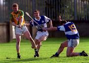 30 October 1999; Ger Cuddy, 19, of Castletown blocks down the attempt of Faughs' Ruari Boland during the AIB Leinster Club Hurling Championship Quarter-Final match between Castletown, Laois, and Faughs, Dublin, at Parnell Park in Dublin. Photo by Ray Lohan/Sportsfile