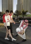 24 January 2007; Ross Munnelly, Laois, left, and Brian Kavangh, Longford, demonstrate Gaelic Football to Ahmed Atiya, an employee of the Royal Meridien Hotel. Royal Meridien Hotel, Dubai, United Arab Emirates. Picture credit: Ray McManus / SPORTSFILE