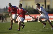 27 January 2007; Ross Munnelly, Laois, supported by James Masters, Cork, Vodafone All Stars 2006, in action against DEclan Lally, Dublin, Vodafone All Stars 2005. Vodafone GAA All Stars Tour 2007, Vodafone All Stars Exhibition Game, Vodafone GAA All Stars 2005 v Vodafone GAA All Stars 2006, Dubai Polo and Equestrian Club, Arabian Ranches, Dubai, United Arab Emirates. Picture credit: Ray McManus / SPORTSFILE
