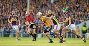 13 September 2014; Conor Cleary, Clare, clears the ball under pressure from Gary Moore, left, and Conor McDonald, Wexford. Bord Gáis Energy GAA Hurling Under 21 All-Ireland 'A' Championship Final, Clare v Wexford. Semple Stadium, Thurles, Co. Tipperary. Picture credit: Ray McManus / SPORTSFILE