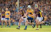 13 September 2014; Conor Cleary, Clare, clears the ball under pressure from Gary Moore, left, and Conor McDonald, Wexford. Bord Gáis Energy GAA Hurling Under 21 All-Ireland 'A' Championship Final, Clare v Wexford. Semple Stadium, Thurles, Co. Tipperary. Picture credit: Ray McManus / SPORTSFILE