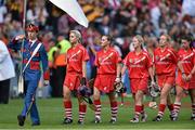 14 September 2014; Cork players, from left, Anna Geary, Aoife Murray, Joanne O'Callaghan, Laura Tracey and Eimear O'Sullivan follow the Artane Band during the pre-match parade. Liberty Insurance All Ireland Senior Camogie Championship Final, Kilkenny v Cork, Croke Park, Dublin. Picture credit: Ramsey Cardy / SPORTSFILE