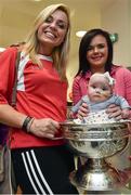 15 September 2014; Cork captain Anna Geary with, 4 month old, Sasha Daniels, from Waterford City, with her mother Shannon Daniels, during a visit by the All-Ireland Senior & Intermediate Camogie Champions to Our Lady's Children's Hospital, Crumlin. Picture credit: David Maher / SPORTSFILE