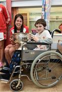 15 September 2014; Gary Monaghan, age 12, from Athboy, Co. Meath, with Cork player Eimerar O'Sullivan, during a visit by the All-Ireland Senior & Intermediate Camogie Champions to Our Lady's Children's Hospital, Crumlin. Picture credit: David Maher / SPORTSFILE