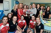 15 September 2014; Members of Cork Camogie team with, 4 month old, Andrew Rolf, with his mother Vivenne Rolf, from Belgooly, Co. Cork, during a visit by the All-Ireland Senior & Intermediate Camogie Champions to Our Lady's Children's Hospital, Crumlin. Picture credit: David Maher / SPORTSFILE