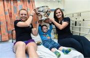 15 September 2014; Jason Harber, age 5, from Kilkenny, Co. Kilkenny, with Cork player's Joanne Casey, left, and Aoife Murray, during a visit by the All-Ireland Senior & Intermediate Camogie Champions to Our Lady's Children's Hospital, Crumlin. Picture credit: David Maher / SPORTSFILE