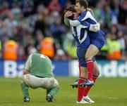 11 February 2007; Lionel Nallet, 4, and Pierre Mignoni, France, celebrate as a dejected Marcus Horan drops to his knees. RBS Six Nations Rugby Championship, Ireland v France, Croke Park, Dublin. Picture Credit: Matt Browne / SPORTSFILE