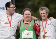 18 September 2014; Team Ireland's Paul Gordon, centre, from Omagh, Co. Tyrone, and a member of Star Breakers Special Olympics Club, with Paolo Bindi, San Poalo, left, and Francois Castin, Belgium, after being presented with a Gold Medal in the 100m event at the Den UYT Sports Centre. 2014 Special Olympics European Games, Antwerp, Belgium. Picture credit: Ray McManus / SPORTSFILE