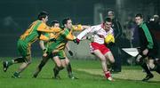 17 February 2007; Tommy McGuigan, Tyrone, in action against Brendan Devenney, Christy Toye, and Barry Dunnion, Donegal. McKenna Cup Final, Donegal v Tyrone, Healy Park, Omagh, Co. Tyrone. Picture credit: Oliver McVeigh / SPORTSFILE