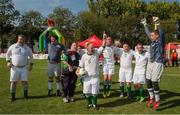 19 September 2014; Team Ireland's Peter Kavanagh, 6, from Ennis, Co Clare, who scored a hat trick, celebrates with the match ball and team mates after the game. Ireland beat Israel 4-0 in the final of the seven a side competition at the Het Rooi Sports Centre in Antwerp. 2014 Special Olympics European Games, Antwerp, Belgium. Picture credit: Ray McManus / SPORTSFILE