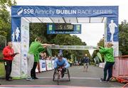 20 September 2014; Patrick Monaghan, Naas AC, crosses the finish line to win the wheelchair race at the SSE Airtricity Dublin Race Series Half Marathon. Phoenix Park, Dublin. Picture credit: Pat Murphy / SPORTSFILE