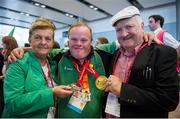21 September 2014; Team Ireland's Oliver Hanratty, a member of St Theresa's Special Olympics Club, Dundalk, Co. Louth, with his parents, Peter and Mary, pictured at Dublin Airport on their return from the 2014 Special Olympics European Games in Antwerp, Belgium. Dublin Airport, Dublin. Picture credit: Tomás Greally / SPORTSFILE