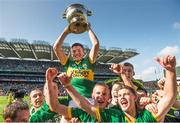 21 September 2014; Kerry's Liam Kearney lifts the Tom Markham cup as his team-mates celebrate. Electric Ireland GAA Football All Ireland Minor Championship Final, Kerry v Donegal. Croke Park, Dublin. Picture credit: Stephen McCarthy / SPORTSFILE