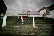 24 February 2007; Cliftonville supporter Connor Begley helps lift litter from the stands at Solitude before the match. Carnegie Premier League, Cliftonville v Loughgal, Solitude, Belfast, Co Antrim. Picture Credit: Russell Pritchard / SPORTSFILE