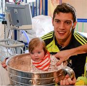 22 September 2014; Caoimhe Spillane, aged 4 months, from Killarney, with Kerry footballer David Moran, during a visit by the All Ireland Senior Football Champions 2014 to Our Lady's Children Hospital. Our Lady's Children Hospital, Crumlin, Dublin. Picture credit: Piaras Ó Mídheach / SPORTSFILE