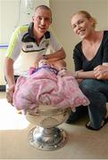 22 September 2014; Ella O'Donoghue, aged 10 weeks, from Killarney, and her mother Gillian, meet Kerry footballer Kieran McDonaghy and the Sam Maguire Cup, during a visit by the All Ireland Senior Football Champions 2014 to Our Lady's Children Hospital. Our Lady's Children Hospital, Crumlin, Dublin. Picture credit: Piaras Ó Mídheach / SPORTSFILE