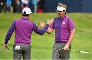 24 September 2014; Team Europe's Rory McIlroy congratulates playing partner Victor Dubuisson after his birdie putt on the 17th green during European Team practice. Previews of the 2014 Ryder Cup Matches. Gleneagles, Scotland. Picture credit: Matt Browne / SPORTSFILE