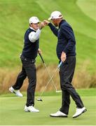 25 September 2014; Team Europe's Rory McIlroy, left, and Thomas Bjorn celebrate after Bjorn made a successful birdie putt on the first. Previews of the 2014 Ryder Cup Matches. Gleneagles, Scotland. Picture credit: Matt Browne / SPORTSFILE