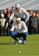 27 September 2014; Ian Poulter and Rory McIlroy, Team Europe, line up a putt on the 8th green during the morning Fourball Match against Jimmy Walker and Rickie Fowler, Team USA. The 2014 Ryder Cup, Day 2. Gleneagles, Scotland. Picture credit: Matt Browne / SPORTSFILE