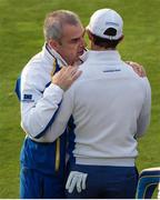 27 September 2014; European team captain Paul McGinley has a word in Rory McIlroy's ear before he tees off at the first during the morning Fourball Match against Jimmy Walker and Rickie Fowler, Team USA. The 2014 Ryder Cup, Day 2. Gleneagles, Scotland. Picture credit: Matt Browne / SPORTSFILE