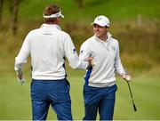 27 September 2014; Rory McIlroy congratulates Ian Poulter, Team Europe, after he chipped into the hole for a birdie on the 15th green during the morning Fourball Match against Jimmy Walker and Rickie Fowler, Team USA. The 2014 Ryder Cup, Day 2. Gleneagles, Scotland. Picture credit: Matt Browne / SPORTSFILE